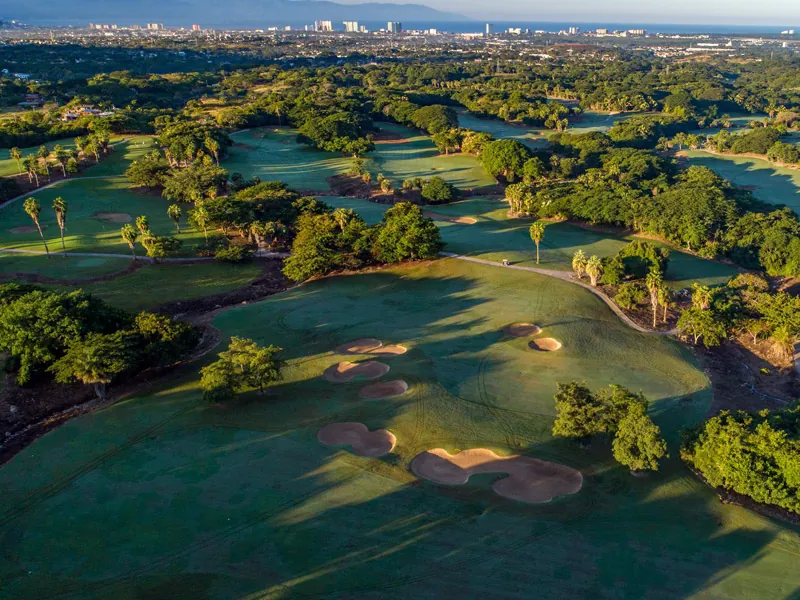 Aerial view of a championship golf course with the bay behind