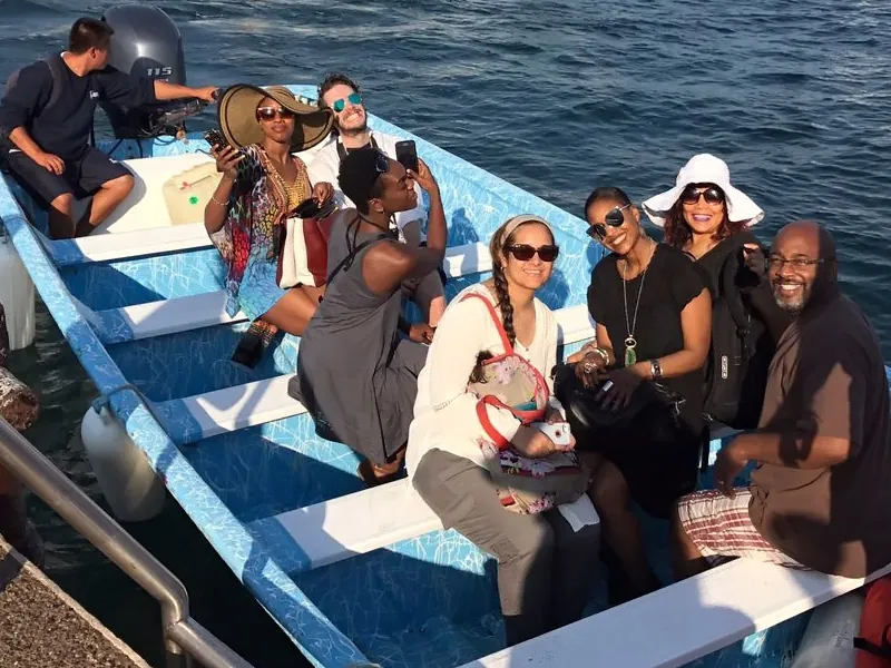 Group of guests seated in a blue panga boat ready to set off for the Marietas