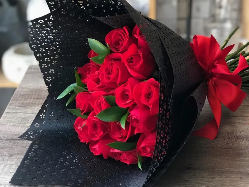 Bouquet of red roses wrapped in black lace