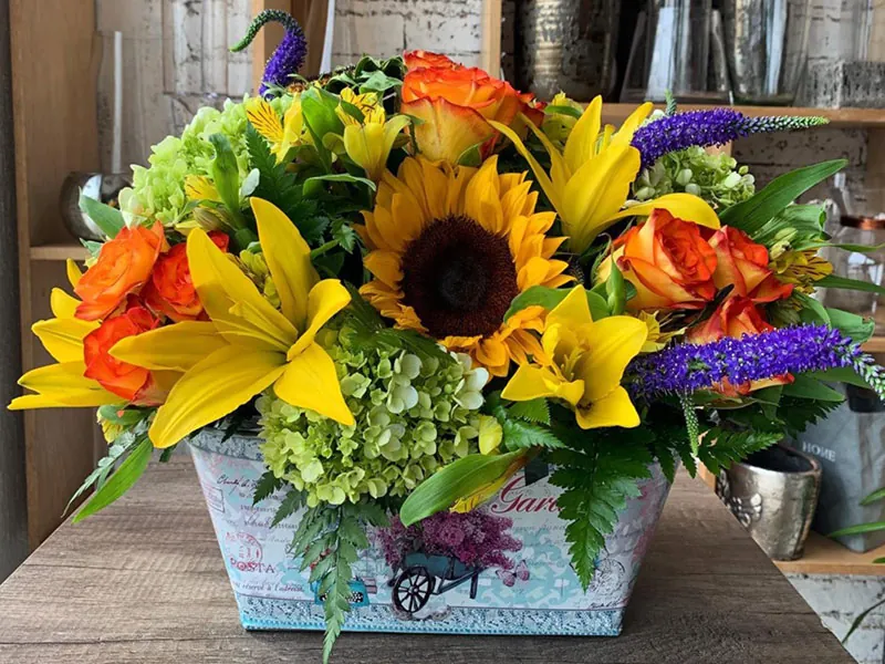 Bright arrangement of sunflowers, lilies and roses