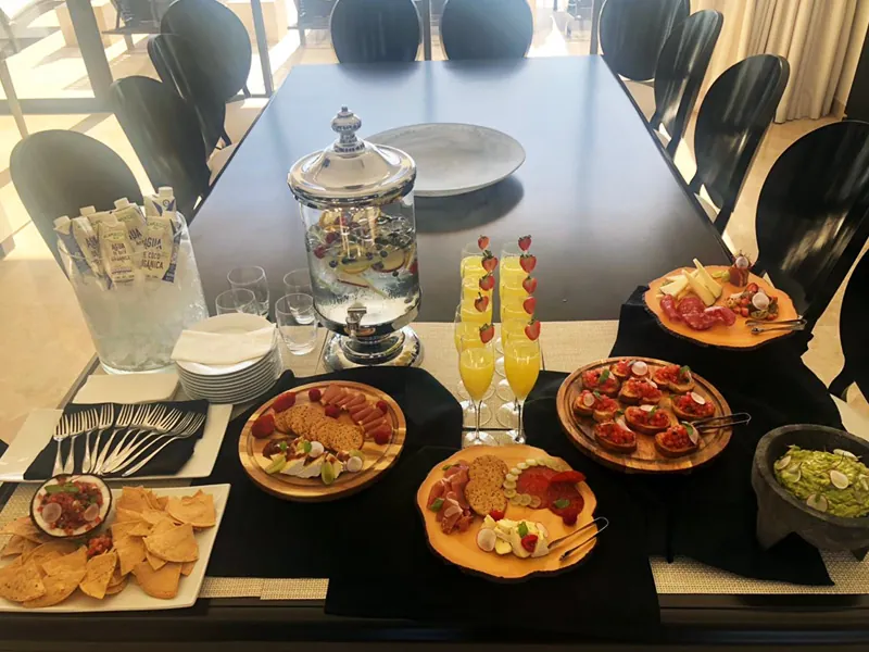 Brunch spread with mimosas, salsas and appetizers on a dining table