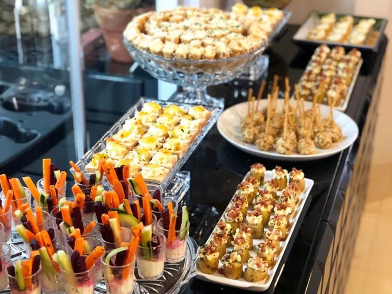 Canapés and vegetable cups arranged on glass stands