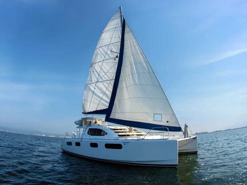 Leopard 46 catamaran under sail on Banderas Bay, low coastline in the distance