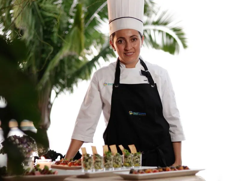 Chef standing behind a buffet of appetizers