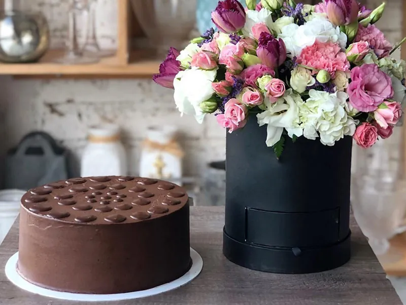 Chocolate cake with a box of flowers
