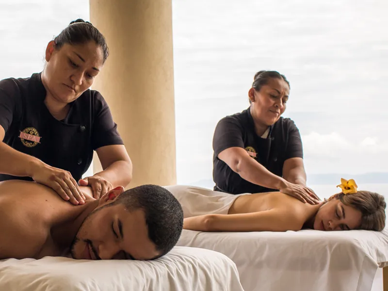 Couples massage on an open-air terrace overlooking the ocean