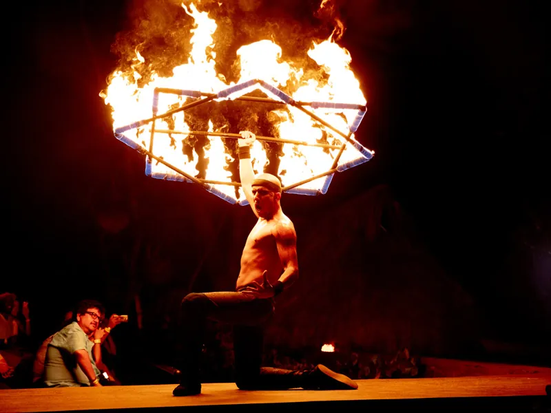 Fire dancer holding a flaming hoop above his head