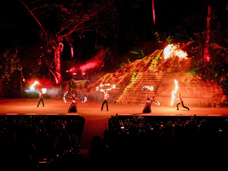 Fire performers in front of the stone pyramid amphitheater