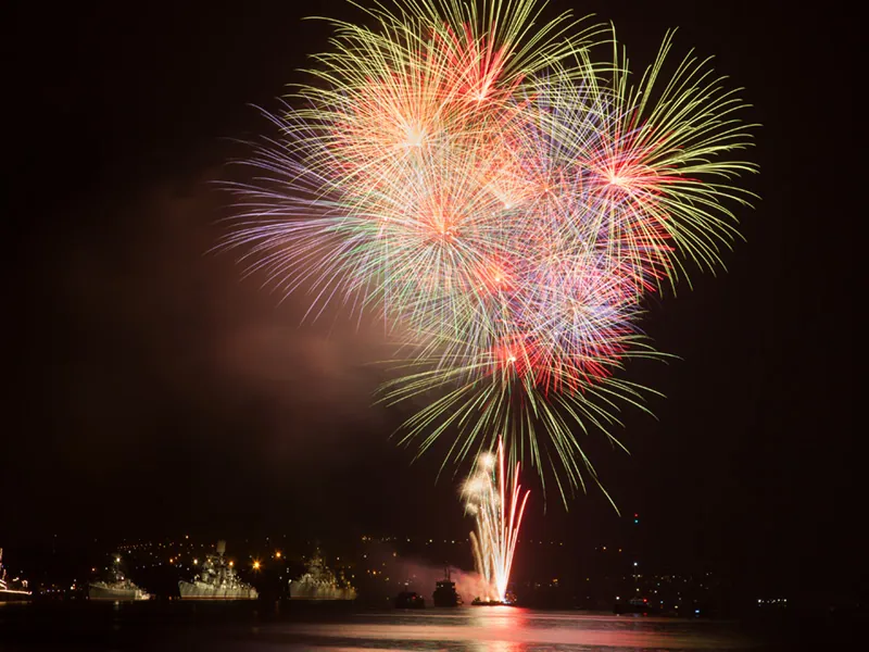 Fireworks bursting over the bay at night