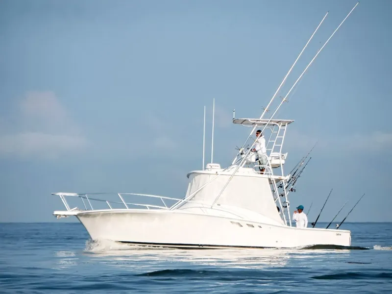 Fishing boat heading out on calm open water