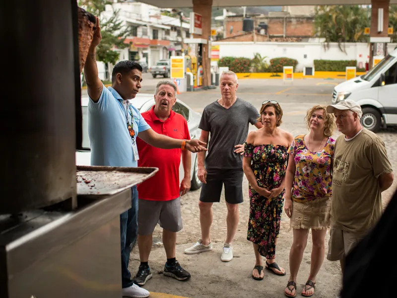 Guide with a small group outside a taco stand