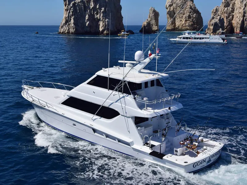 Hatteras 70 sportfishing yacht under way near the rocks of Land’s End, Cabo San Lucas