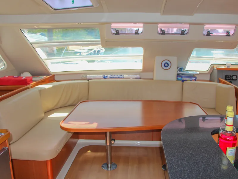 Cream-upholstered saloon and dining table inside the Leopard 46 catamaran