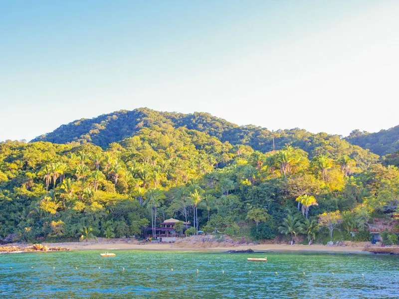 Las Caletas cove seen from the sea, jungle-covered hills behind