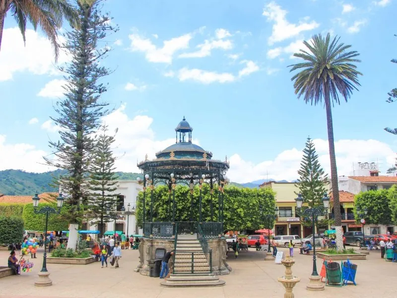 Wrought-iron bandstand and tall palms in the main square of Mascota