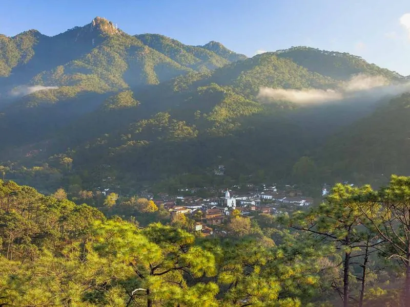Mist over the Sierra Madre mountains above the village