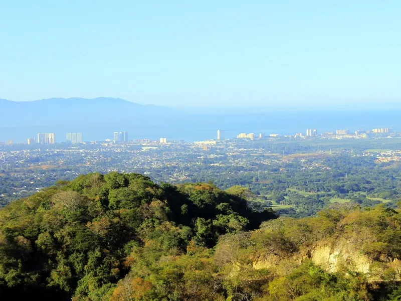 View from the mountain trail over the green foothills, Puerto Vallarta and the bay