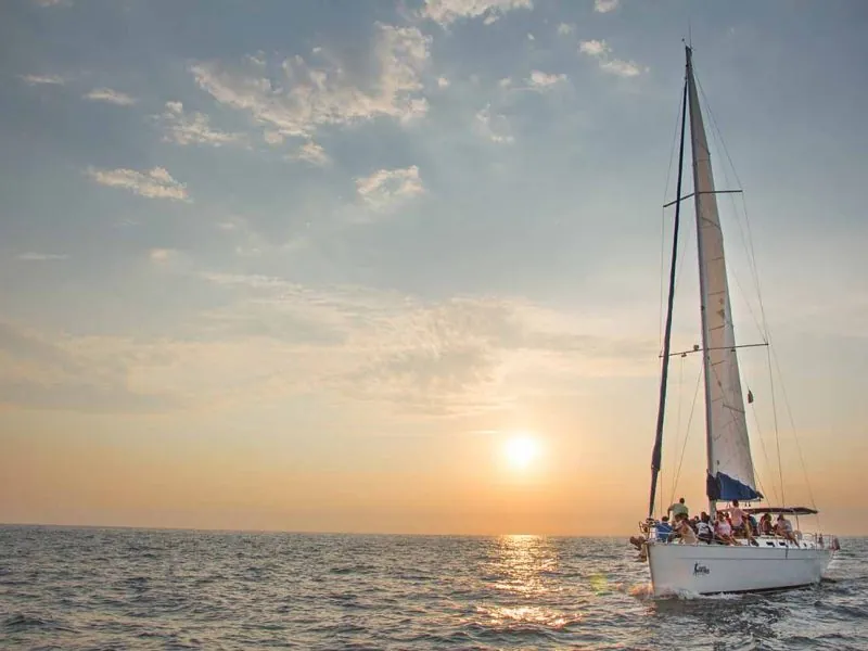 Sailboat silhouetted against the setting sun