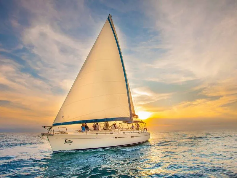 Sailboat with full sails at sunset on Banderas Bay