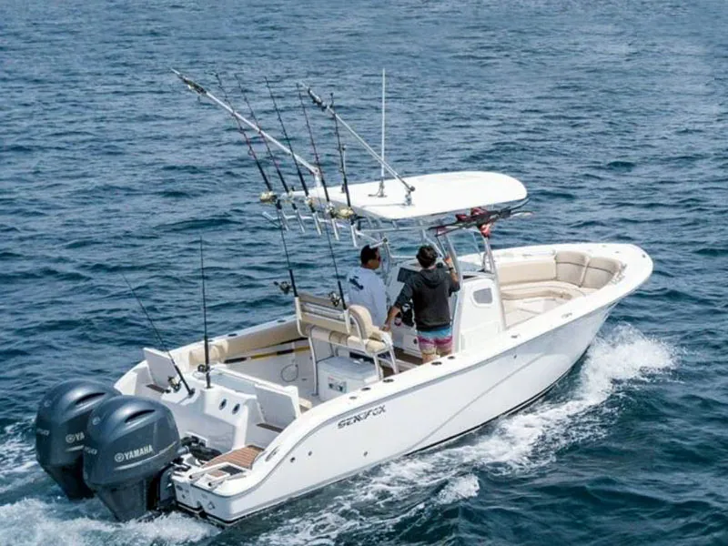Sea Force 26 center-console boat with rods in the rack, running at speed