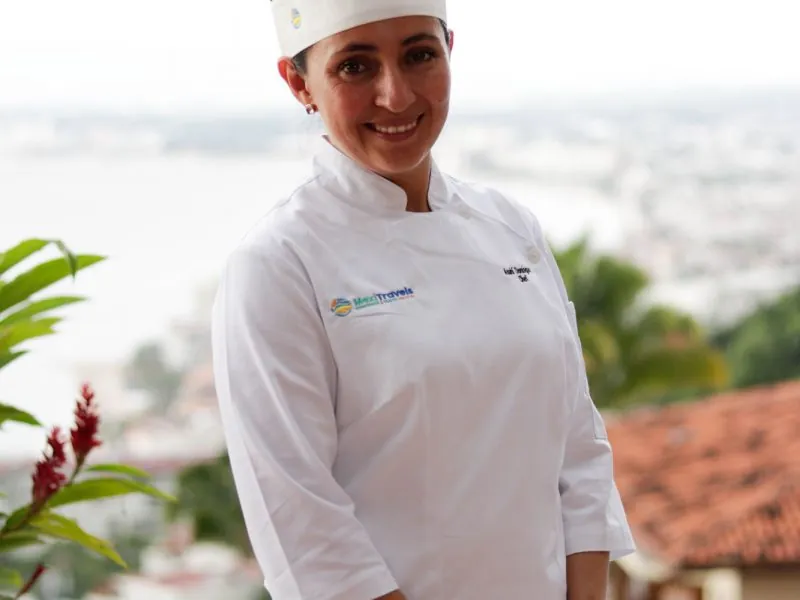 Smiling chef in whites on a terrace above Puerto Vallarta