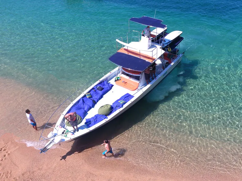 Speedboat pulled up on a turquoise beach
