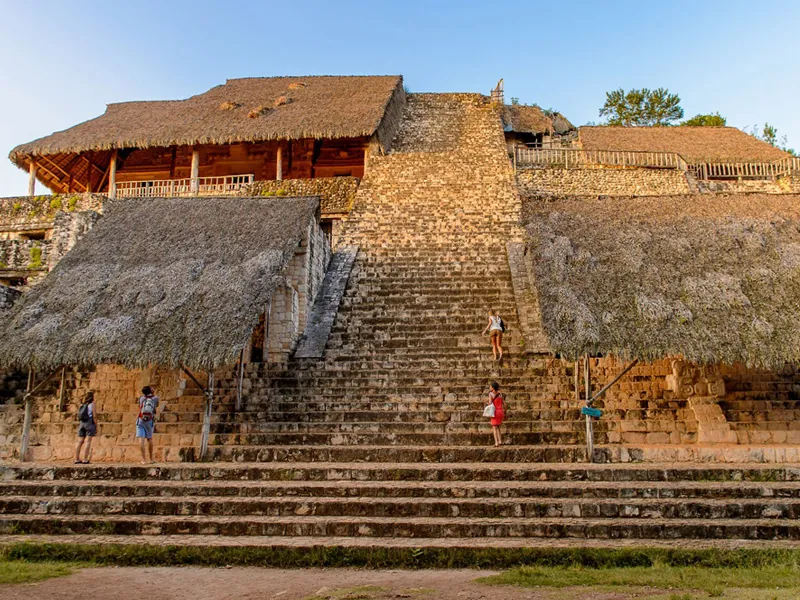The wide stone staircase of the acropolis at Ek Balam, with palm-thatched shelters over its upper levels