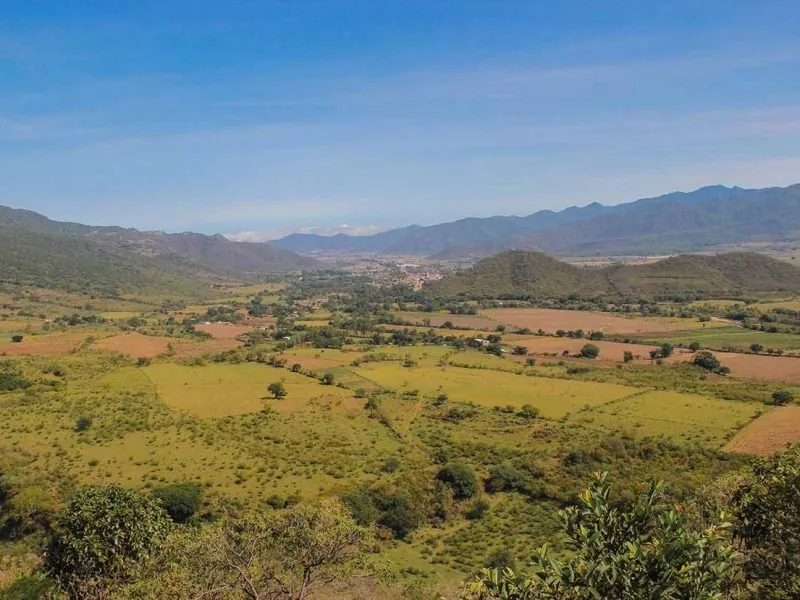 Farmland of the Mascota valley ringed by Sierra Madre mountains under a hazy sky