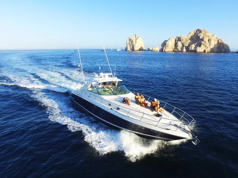 Sea Ray yacht cruising at speed with the Land’s End rocks on the horizon