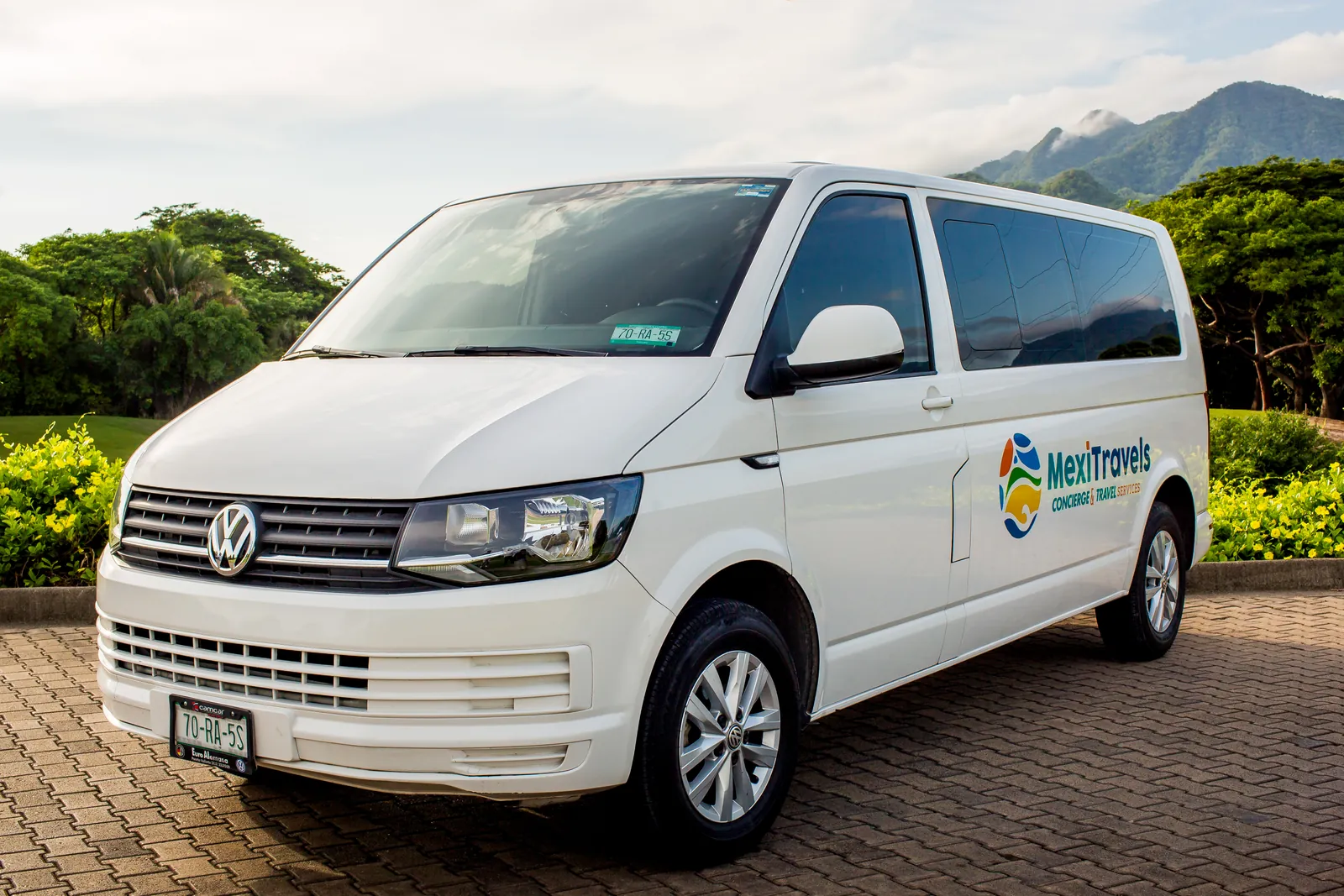White Volkswagen Transporter van parked on a stone driveway